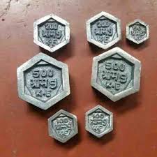 Small cast iron calibration weights from fifty grams to two kilograms